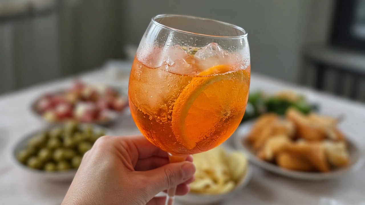 Close-up of a bubbly Aperol spritz with an orange slice